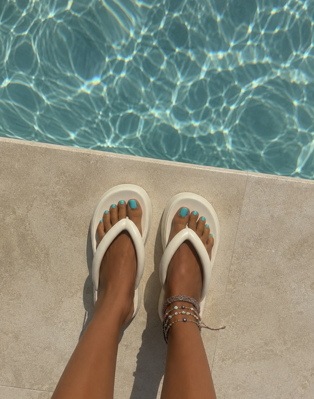 White platform flip flop sandals.
