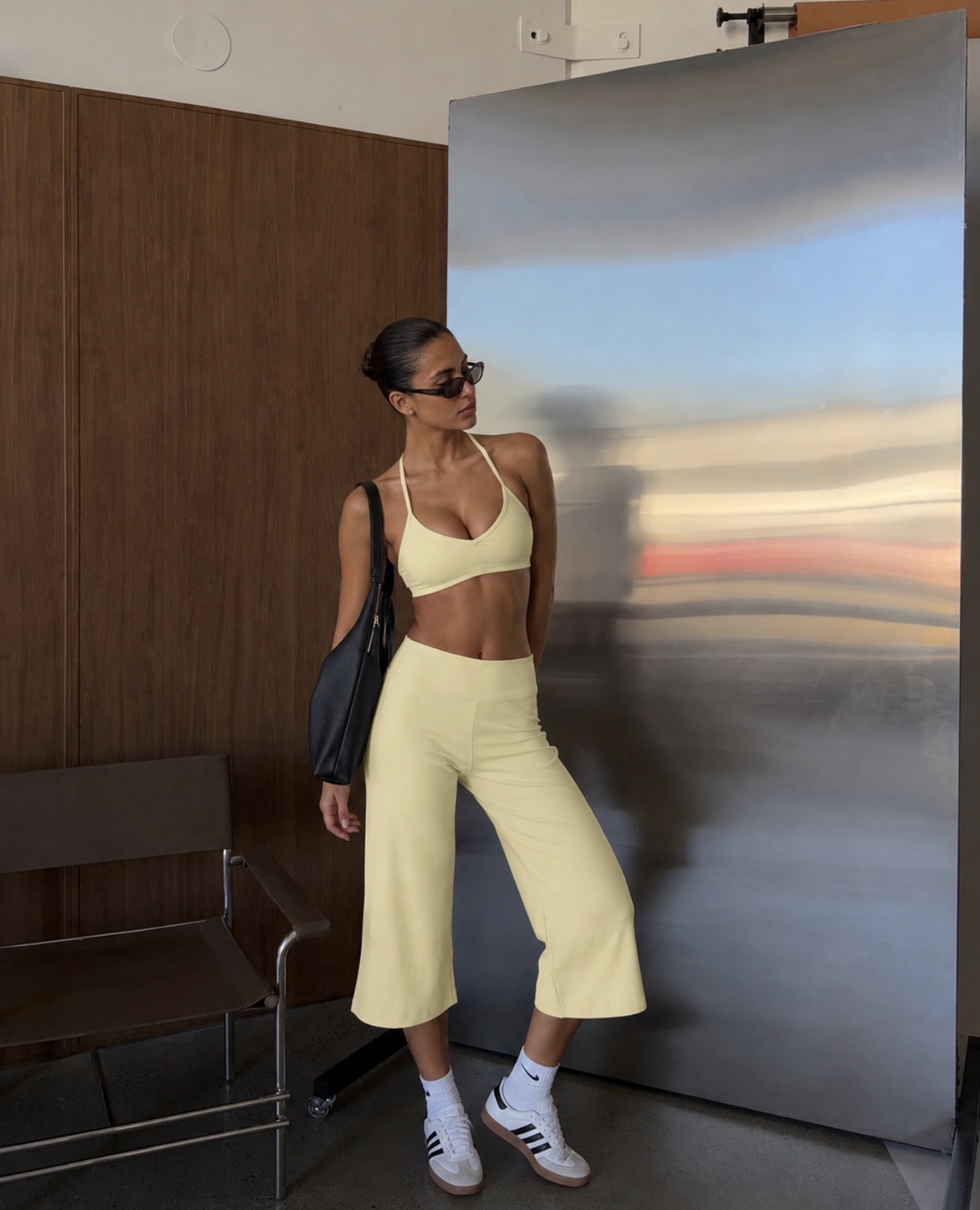 Butter yellow capri workout set, white adidas sneakers, black hobo bag