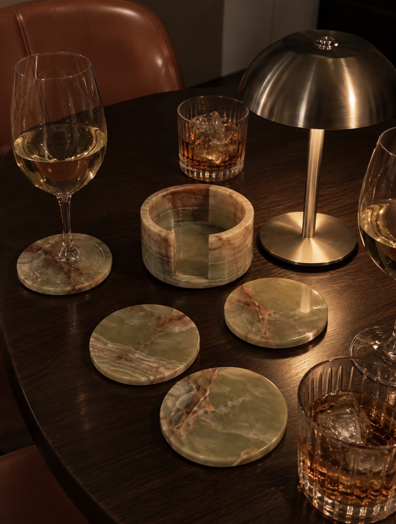 A SOPHISTICATED TABLESCAPE — Set the mood with a sleek metallic table lamp and elegant stone coasters. The perfect finishing touches for a luxe table